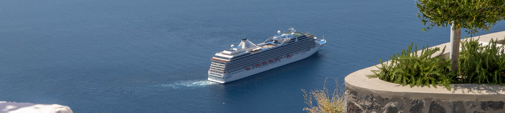 Aerial view of Oceania Riviera sailing past Santorini, Greece